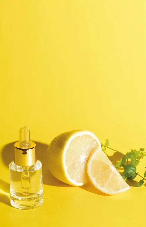 Serum bottle beside sliced lemon