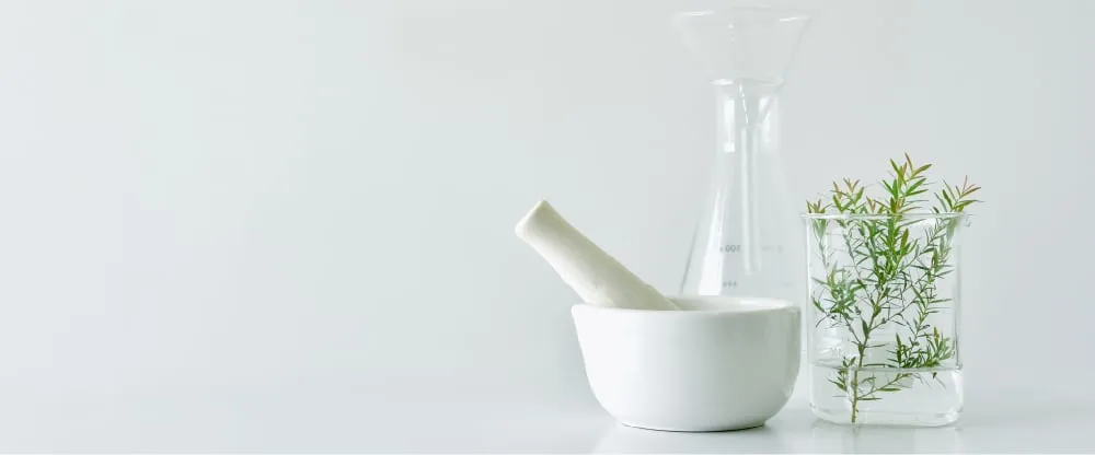 Mortar and pestle with rosemary and glassware