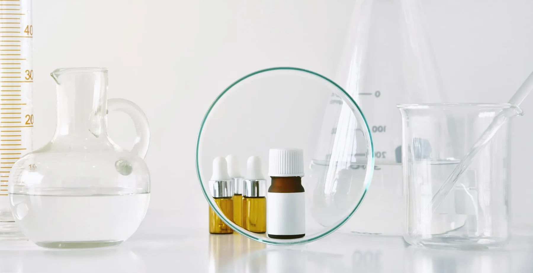 Laboratory glassware and small bottles on a bench